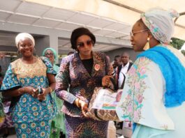 National President, Defence Police Officers Wives Association (DEPOWA), Mrs Oghogho Musa, receiving paliatives from the Honourable Minister of Women Affairs, Hajia Imaan Sulaiman-Ibrahim, on behalf of the Group