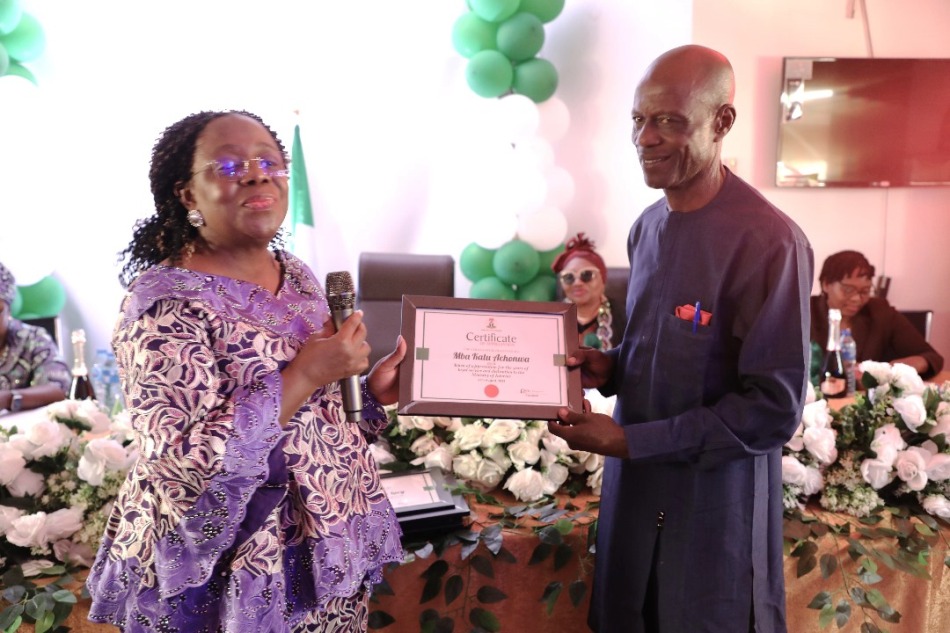 The Permanent Secretary, Ministry of Interior, Dr. Magdalene Ajani, presenting a certificate of appreciation to Mr. Mba Kalu Achonwa at the send-forth ceremony.