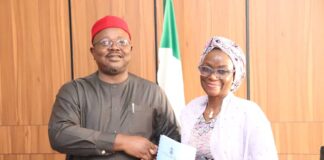 L-Dr. Onwusoro Maduka Ihemelandu, with Dr. Maryam Ismaila Keshinro-R, performing handover ceremony with a hanshake