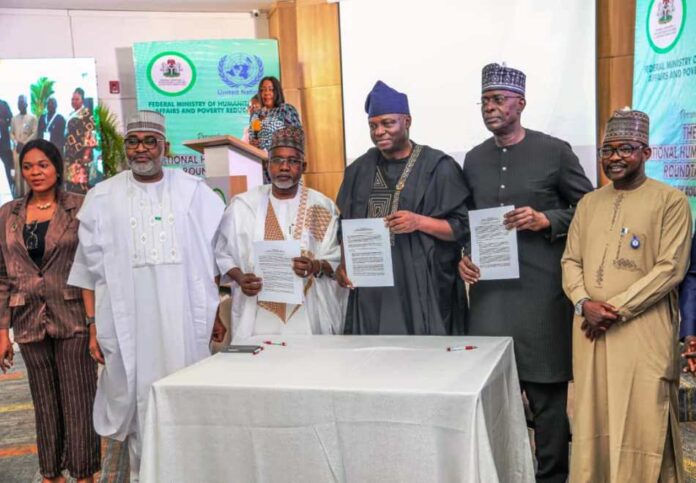 L-R, Honourable Minister of State, Federal Ministry of Regional Development, Uba Amadu Magari, Honourable Minister of State Federal Ministry of Humanitarian Affairs and Poverty Reduction Dr Yusuf Tanko Sununu, Honourable Minister of Humanitarian Affairs and Poverty Reduction Professor Nentawe Goshwe Yilwatda, United Nations, Resident Coordinator in Nigeria Mohamed Malik Fall, and members of the Communique drafting committee showcasing the signed copy of the Communique of the two-day National Humanitarian Roudtable held on Wednesday 26th March,2025 in Abuja