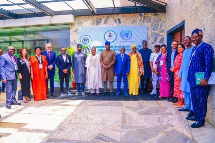 8th left, Honourable Minister of Humanitarian Affairs and Poverty Reduction Professor Nentawe Goshwe Yilwatda, 9th left, Minister of State of the Ministry, Dr Yusuf Tanko Sununu, 7th left, Honourable Minister of Budget and Economic Planning Senator Abubakar Atiku Bagudu, 9th left, UN Resident Coordinator in Nigeria Mohamed Malik Fall , 1st left, Representative of the Permanent Secretary of the Ministry, Valentine Ezulu and other dignitaries during the Humanitarian Roudtable with stakeholders, organized by the Ministry on Tuesday 25th March 2025, in Abuja.