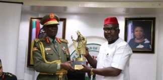 L to R, Maj. Gen. G. Igumba Commadant, SCSC, Kimaka and the Director of Federal Ministry of art Culture, Tourism and Creative Economy, Rev. Cannon Dr. Anamah NUB, Department of (CI&H) Giving Gift Items to the Commandant.
