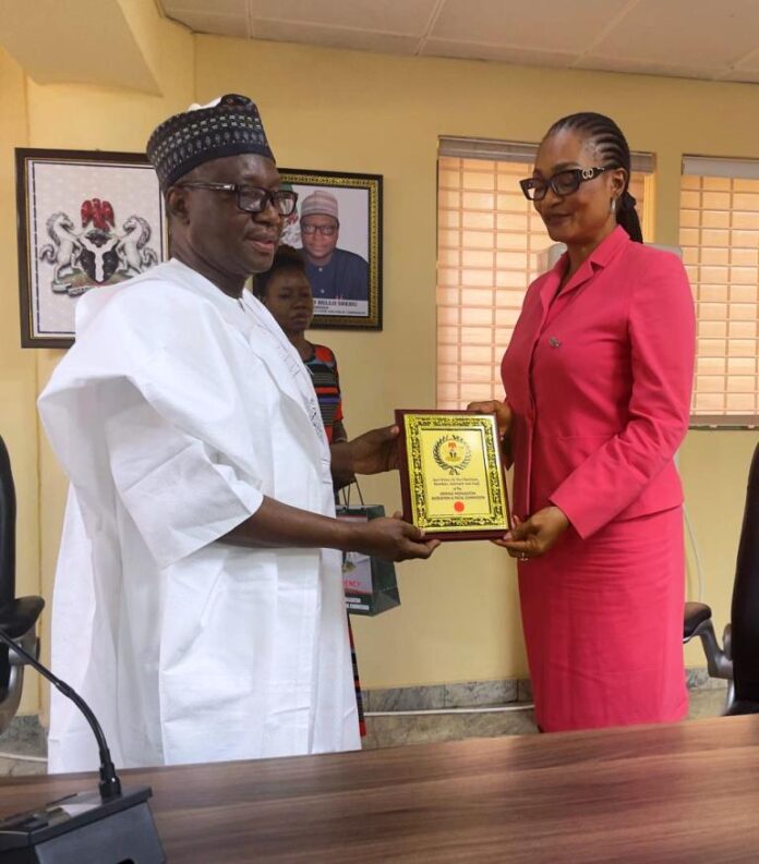 RMAFC Chairman, Dr. Mohammed Bello Shehu OFR, presenting a memorabilia to the visiting Director General of ALGON, Barr. Evan Enekwe at RMAFC HQ, Abuja.