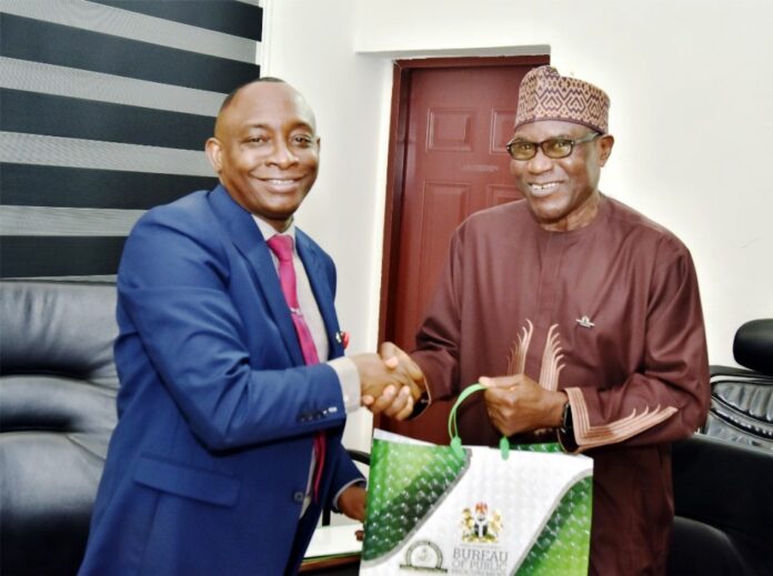 L-R: Director-General, Bureau of Public Procurement, BPP, Dr. Adebowale A. Adedokun, MCIPS, ACFE presenting a souvenir to the Chairman, Council of Registered Builders of Nigeria (CORBON), Dr. Samson A. Opaluwah, during his courtesy visit to BPP