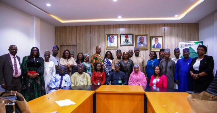 The Permanent Secretary of the Ministry of Communication Innovation and Digital Economy Mr Adeladan Rafiu Olarinre in a group photograph with the Head of Service of the Federation with other Dignitaries on a field visit on the ECM implementation today 23rd June, 2025 at the Permanent Secretary's conference room 6th floor, Federal Secretariat Abuja.