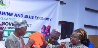 Director, Maritime Services Department, Dr. Mercy Ilori presents the life jacket to the Secretary to the Government, Kwara State, Prof. Mamman Saba Jibril.