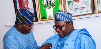 Director General and Chief Executive of the National Space Research and Development Agency Dr. Matthew Adepoju decorating Surveyor General of the Federation Surv. Abudulganiyu Adeyemi Adebomehin with his organisation symbolic lapel pin