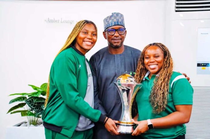 The Chairman National Sports Commission, Mallam Shehu Dikko flanked to the right is the D Tigress Coach, Rena Wakama and to his left, the team Captain, Arny Okonkwo during the presentation of the trophy at the presidential Villa, Abuja recently.